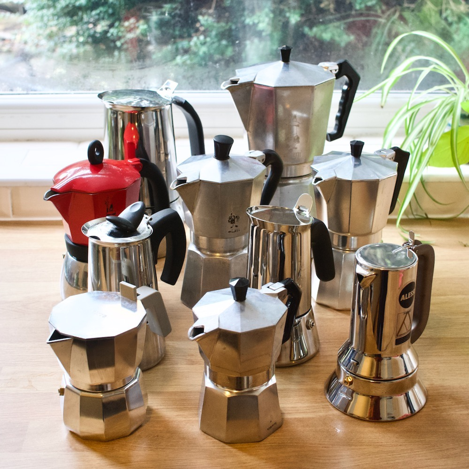 Step-by-step visual guide showing how to clean a Bialetti moka pot – disassembled parts, soft sponge, and vinegar soak for descaling