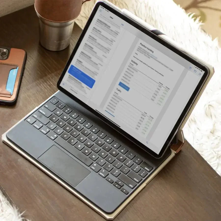 Clean iPad screen with a lint-free microfiber cloth and gentle circular motions, next to a bottle of Windex crossed out to indicate danger.