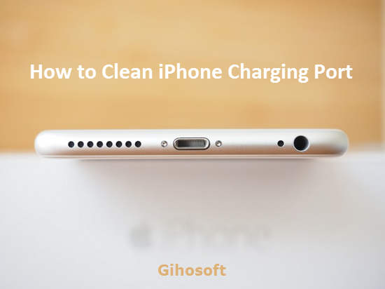 A close‑up view of an iPhone charging port being carefully cleaned with a wooden toothpick, while a flashlight illuminates the delicate internal pins.